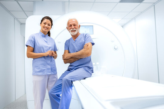 Portrait of female radiologist and senior patient before MRI or CT scanning procedure.