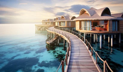 Fotobehang Over water villas line in Maldivas with wooden foot bridge at sunset, holiday ad travel concept   © IRStone