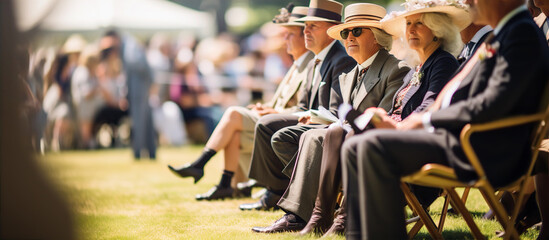 Fototapeta na wymiar Well dressed English people watching Horse racing event at summer sunny day