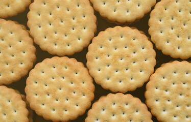 Detailed picture of round sandwich cookies with coconut filling. Background image of a close-up of several treats for tea