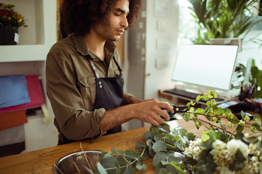 Male Florist Making Floral Design In Flower Shop