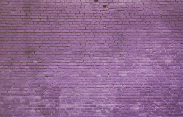 The texture of the brick wall of many rows of bricks painted in violet color