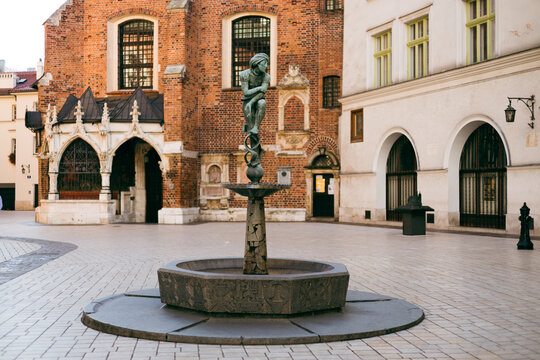 Krakow, Poland - September 20, 2023. Bronze statue of a student known as Zak on the fountain in Krakow, Poland. Monument is located at St. Mary Square in Krakow, listen by UNESCO organization