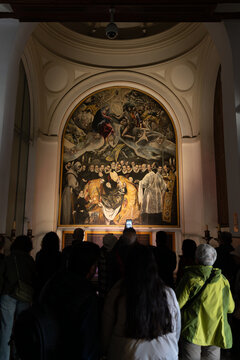 Tourists observing the painting by El Greco "The Burial of the Count of Orgaz", an oil painting on canvas between the years 1586 and 1588 inside the parish of Santo Tom&eacute; in Toledo, Spain.