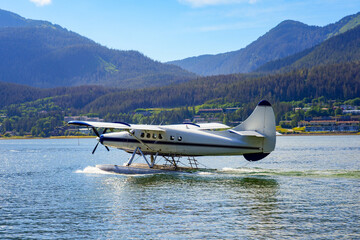 Seaplane landing in the waters of the Gastineau Channel in Juneau, the capital city of Alaska, USA...