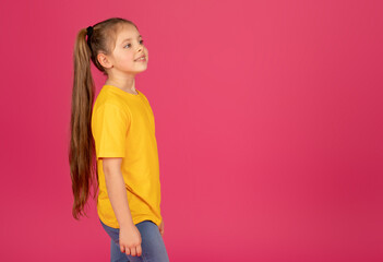 Cute Preteen Girl In Yellow T-Shirt Looking Aside At Copy Space