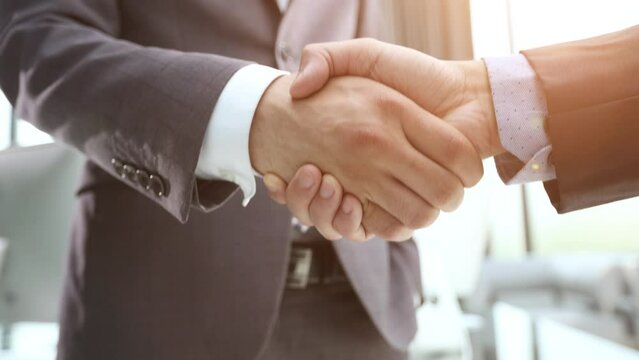 Building a strong business network. two businessmen shaking hands in a modern office