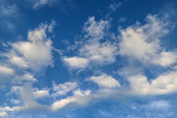Naklejka na ściany i meble Blue sky with fluffy clouds. Abstract tranquil background
