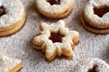 Star shaped Linzer Christmas cookie filled with strawberry marmalade, dusted with sugar