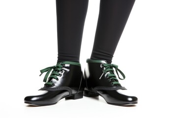 Irish dancer feet in black shoes on white background. Legs in hard shoes for irish dancing. legs in black leather shoes dancing national Irish dances.