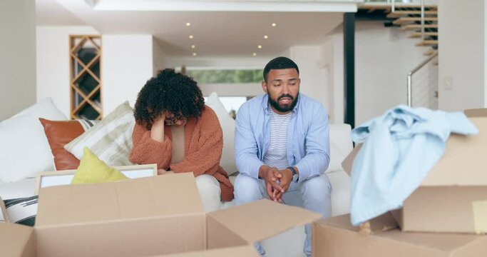 Frustrated couple, sofa and boxes in debt, financial crisis or stress for repossession in new home. Upset man and woman in finance struggle, problem or difficulty with packages for sale to save house