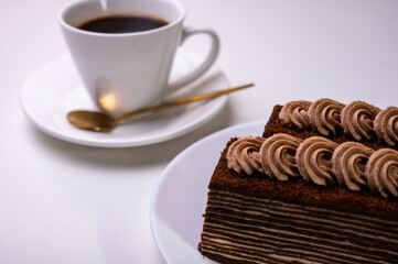 Delicious Spartacus cake on a white plate, close-up. Light background