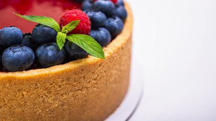 cheese cheesecake close-up view decorated with fresh berries, blueberries and raspberries