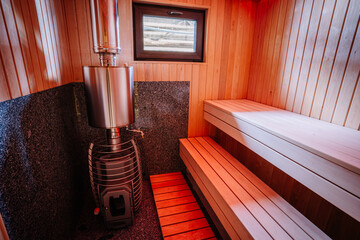 Modern sauna design with led lights and sauna stove.