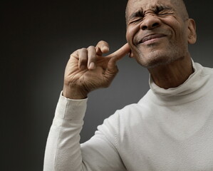 suffering from deafness and hearing loss on grey black background with people stock image stock...
