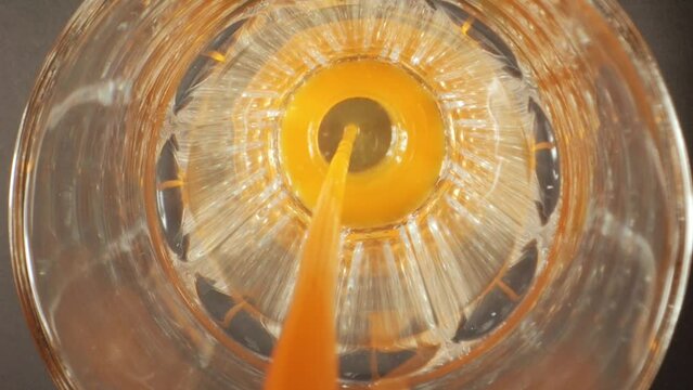 Pouring Fresh Juice into Glass close up. Slow Motion Pour juice. Pouring Fresh Orange Juice.