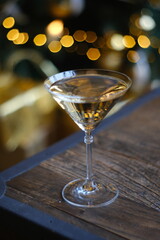 Gold Christmas background. New Year champagne and sparkling wine are pouring into a festive glass. New Year and Christmas theme.