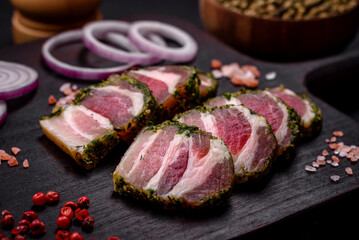 Delicious fresh bacon stripes with spices and salt