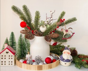 Beautiful holiday card.  Merry Christmas and New Year greeting concept.  On a white background, a vase with decorated fir branches, a ceramic house, cute Santa Claus.  Foreground.