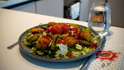 Falafel Salad as a dish and a glass of water for dinner