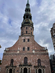 Fototapeta premium High old tower landmark in a Cathedral with a beautiful old peak in Riga, Latvia