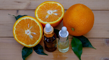 Essential extract of orange oil in a small bottle. Selective focus.
