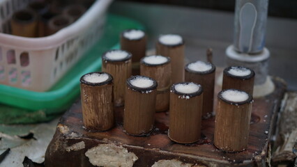 The process of making putu cake which is put into a mold made of bamboo and then steamed with steam, a traditional Indonesian snack.