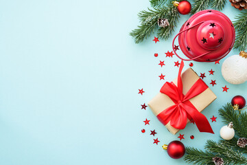 Christmas composition or greeting card. Christmas present box, candle and decorations at blue. Flat lay image with copy space.