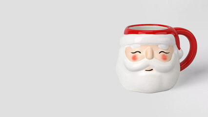 Closeup of Christmas Santa Claus mug on grey copy-space background.