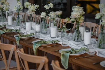The wedding table decorated with fresh flowers.  © Ekaterina Pichukova