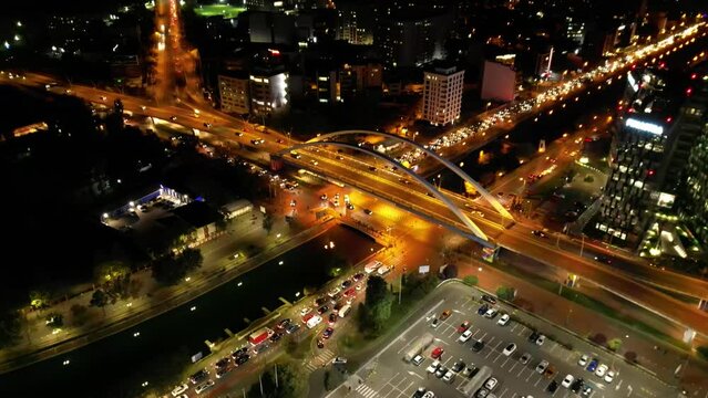 High angle drone night cityscape of Bucharest Romania. Night flyover shot of illuminated european city. Night cityscape from up above. Beautiful night lights of a bug urban area. Establishing shot.
