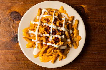Loaded cheese fries with bacon and ranch dressing