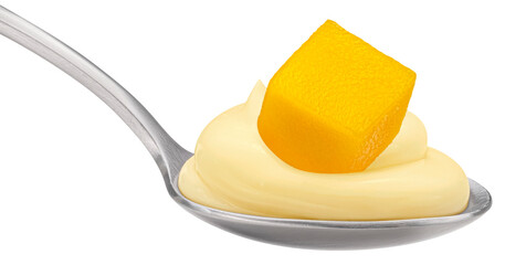 Spoon of fruit yogurt and mango piece isolated