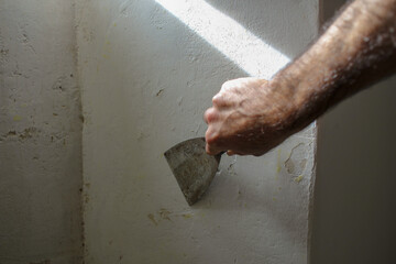 preparing an old house wall for painting