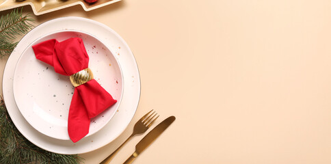 Beautiful Christmas table setting on beige background with space for text