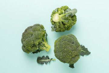Flat lay with fresh broccoli on color background