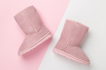 Beautiful childish boots on color background,top view