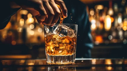Foto op Aluminium Side view of a woman's hand Pouring a whiskey in a glass on bar counter Bokeh background in restaurant  © CStock