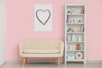 Modern shelf unit with sofa near white brick wall