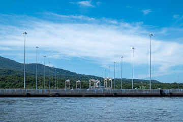 Large Industrial Seaport with Several Light Poles at Mid-Day by a Volcanic Mountain
