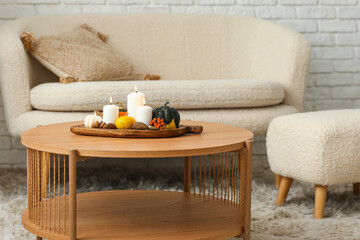 Wooden board with burning candles and natural forest decor on table