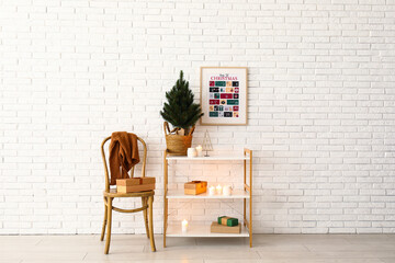 Interior of living room with Christmas calendar, chair and shelf unit