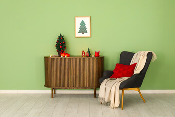Interior of living room with Christmas calendar, armchair and drawers