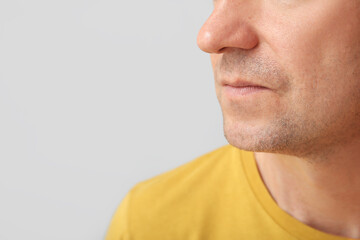 Fototapeta premium Mature man on grey background, closeup