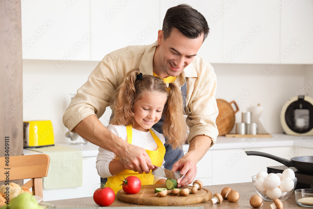 Canvas Prints Cute little girl with her dad cutting cucumber in kitchen