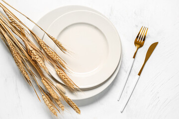 Stylish autumn table setting with ears of wheat on white background