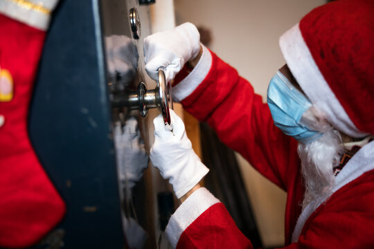 Person Dressed as Santa Tries to Open a Home Security Deposit - Property Security is at Greater Risk during Christmas time