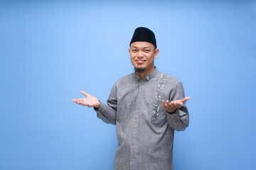 funny asian muslim man posing dizzy, confused, and dont know gesture with surprised face expression...