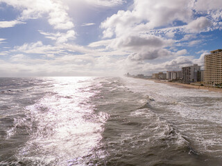 Ocean waves on the beach with bright sun