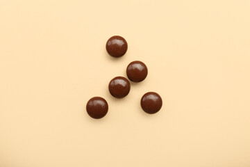 Brown medical pills on beige background
